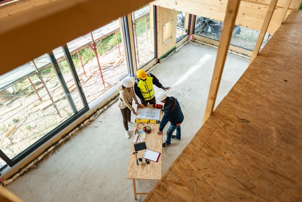 owner builder laising with tradespeople